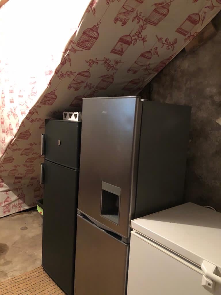 Kitchen appliances tucked under the stairs